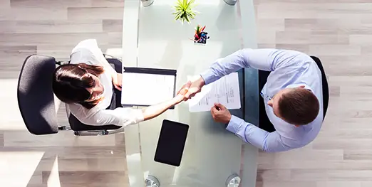 birds eye view of two business people shaking hands